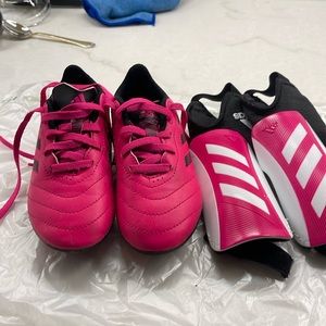 Size 12 soccer shoes and shin guards. Worn 5 times.